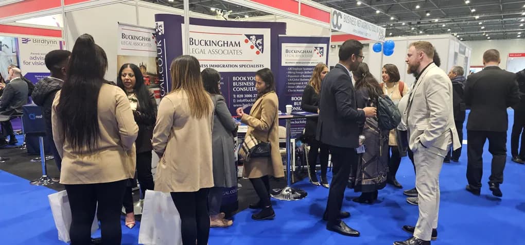 Buckingham Legal Associates exhibition booth with team and visitors